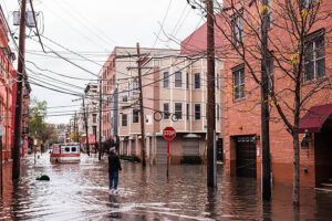 man looking at flooded buildings