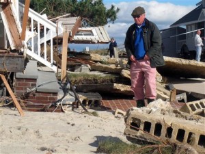 Peter Green looks at the wreckage of his oceanfront home in Bay Head, N.J. on Oct. 31, 2012. He says youths stole golf clubs from the ruins of his home on a stretch of Jersey shore that was devastated by Hurricane Sandy. (AP Photo/Wayne Parry)