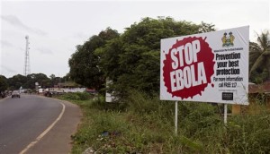 In this photo taken on Tuesday, Oct. 21, 2014, a billboard reading 'Stop Ebola' on the Masiaka Highway, forming part of a trans-West African highway, which links all West African States, on the outskirts of the capital city of Conakry, Guinea. Despite stringent infection-control measures, the risk of Ebolas spread cannot be entirely eliminated, Doctors Without Borders said Friday, Oct. 24, 2014, after one of its doctors caught the dreaded disease while working in Guinea and went to New York City. (AP Photo/ Youssouf Bah)
