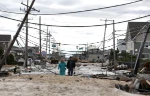 A couple walks between houses destroyed by the disaster