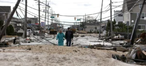 A couple walks between houses destroyed by the disaster