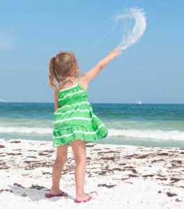 girl throwing sand