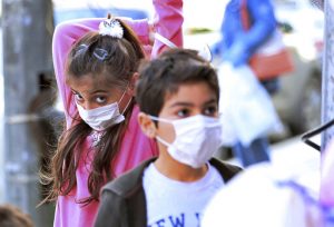 Children wearing masks. AP Photo/Hadi Mizban