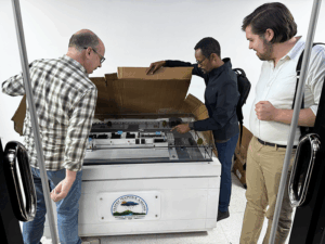Sinegiorgis shows Jeff and Max the models for EMI’s new data servers.